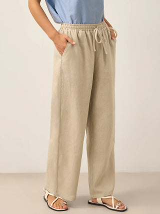 Khaki linen classic pants by LINTICO, 100% linen bottoms with a relaxed fit and tailored design, shown on a model.