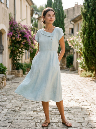 LINTICO Fiona linen midi dress with crescent collar and flutter sleeves, featuring a relaxed, elegant design for warm weather.