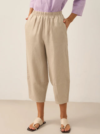 Light taupe linen crop pants for women, stylish LINTICO Rory bottoms with relaxed fit and breathable fabric.