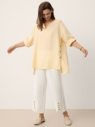 LINTICO Daphnea 100% linen oversized top with curved hem in soft butter color, relaxed fit, and lightweight breathable fabric.