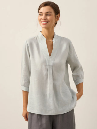 LINTICO Joanna 100% linen dress shirt in mist blue, featuring a classic blouse design with a collar and button-front detail.