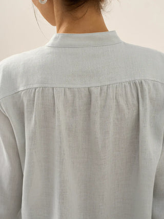 LINTICO Joanna 100% linen dress shirt in mist blue, featuring a classic blouse style with a button-up front and collar.