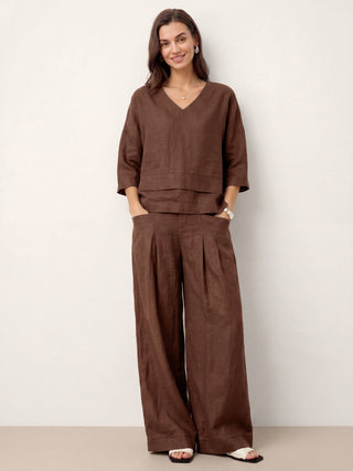 LINTICO 100% linen drop shoulder layered hem overtop in espresso brown, featuring asymmetric design and relaxed fit.