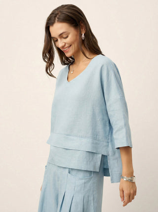 Sky blue linen drop shoulder top with asymmetric layered hem by LINTICO, casual and stylish layered shirt.