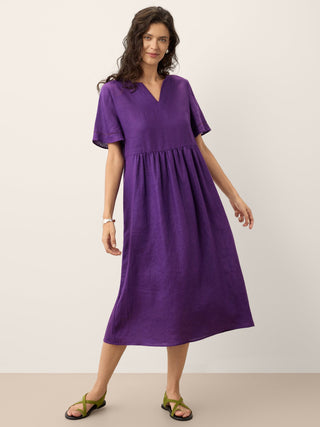 Dark purple linen maxi dress by LINTICO with embroidered cuffs, split neckline, and relaxed fit, perfect for casual and summer wear.