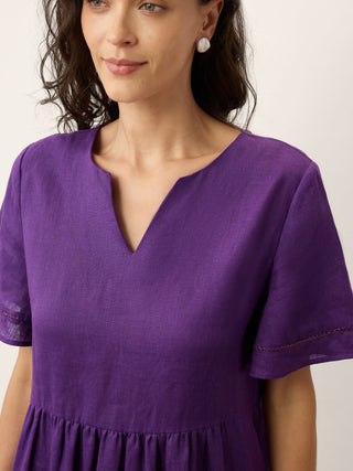 Dark purple linen maxi dress with embroidered cuffs and split neck, by LINTICO, featuring elegant, breathable fabric and stylish design.
