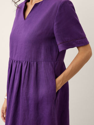 Dark purple linen maxi dress with embroidered cuffs, split neckline, and relaxed fit from LINTICO's Octavia collection.