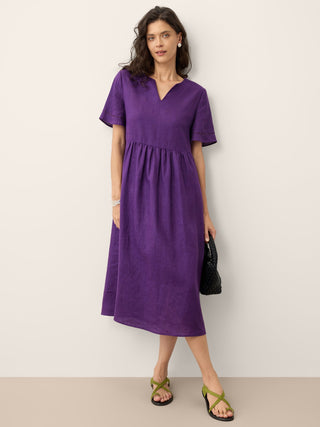 Dark purple linen maxi dress with embroidered cuffs and split neck, by LINTICO, featuring elegant midi dress design.