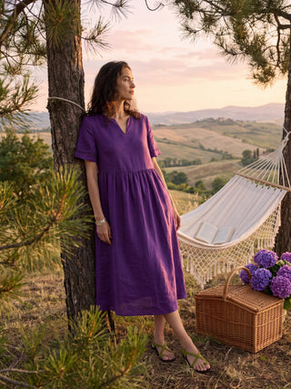 Dark purple linen maxi dress with embroidered cuffs, split neckline, and relaxed fit, designed by LINTICO.