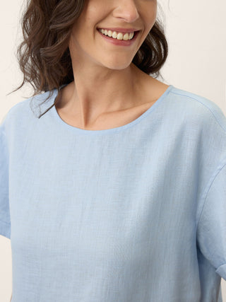 LINTICO Morgan short-sleeved linen midi dress with pinstripe panels in baby blue, featuring a relaxed fit and classic style.