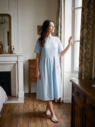 LINTICO Morgan linen pinstripe short-sleeved midi dress in baby blue, featuring paneled design and lightweight fabric.