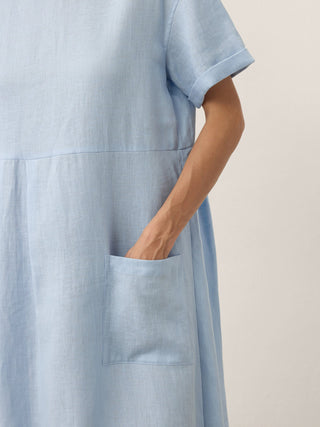 LINTICO Morgan baby blue linen midi dress with pinstripe panels and short sleeves, elegant and lightweight for warm weather.