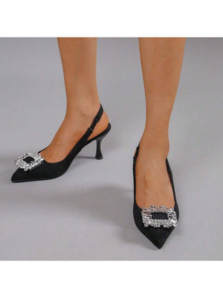 Black suede heels from J.Adams Abigail collection, featuring a classic pointed toe and elegant stiletto heel.