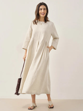 LINTICO Abigail linen maxi dress with bateau neckline and pleated skirt, showcasing lightweight, natural fabric and elegant design.
