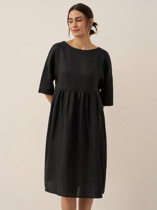 LINTICO 100% linen A-line midi dress named Valencia, featuring a flowing silhouette and lightweight fabric, shown on a model.