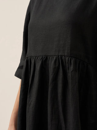 LINTICO 100% linen A-line midi dress with a flowy silhouette, shown in natural light with a soft fabric texture.