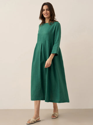 LINTICO 100% linen bateau neck pleated maxi dress with flowing silhouette, showcased on a neutral background.
