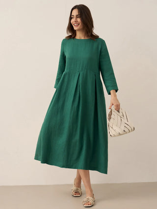 LINTICO Abigail linen maxi dress with bateau neckline and pleated design, showcased in a natural, flowing fit.