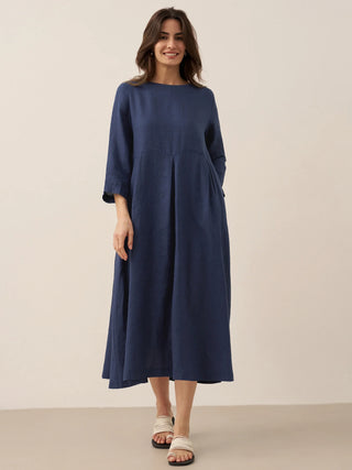 LINTICO Abigail linen maxi dress with bateau neckline and pleated design, flowing and elegant for summer wear.