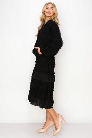 Black Willa Lace Ruffled Skirt by Joh Apparel, featuring delicate lace and elegant ruffles, styled with a black top.