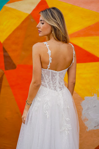 Lara New York Lara 51042 white sheer lace bridal ballgown dress with a fitted bodice and full skirt on model.