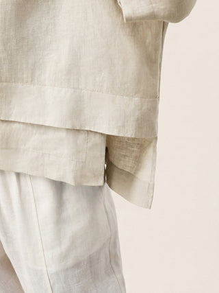 Natural melange linen drop shoulder layered hem top by LINTICO, showcasing its relaxed fit and asymmetric design.