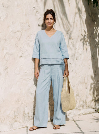 Sky blue linen drop shoulder layered hem overtop shirt by LINTICO, stylish asymmetric design, lightweight and breathable fabric.