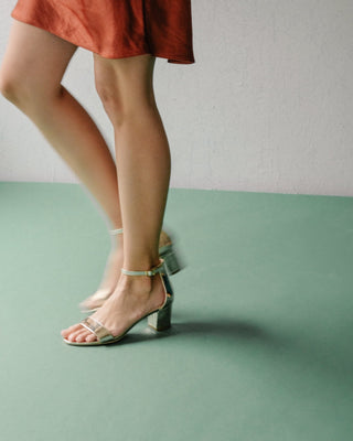 White gold Daisy heels by J.Adams featuring elegant strappy design and pointed toes, showcased on a neutral background.