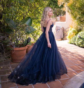 Navy Yasmin Gown by Lady Black Tie featuring a tulle A-line dress with a pleated bodice and elegant flowing skirt.