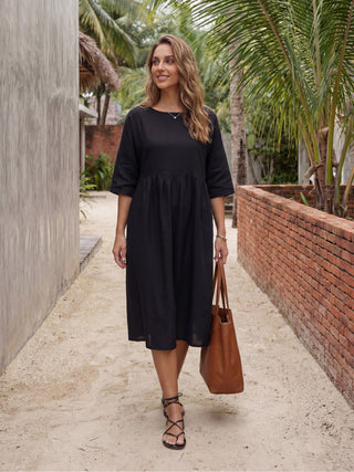Charcoal black 100% linen A-line midi dress by LINTICO, featuring a flowing silhouette and elegant design.