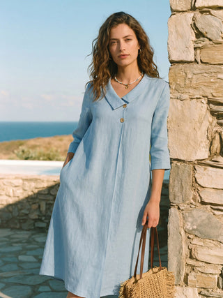 Ice blue linen A-line midi dress with asymmetric shawl collar by LINTICO, perfect for stylish, comfortable summer wear.