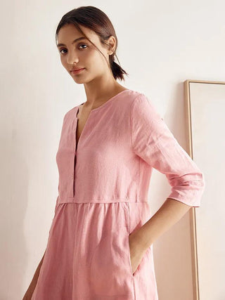 LINTICO linen maxi dress with loose fit, button waist, and gathered design in natural fabric, styled for a relaxed look.