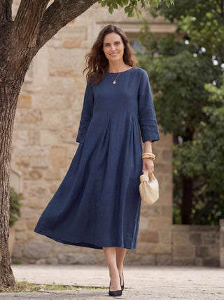 Navy blue 100% linen maxi dress with bateau neckline and pleated design by LINTICO, perfect for elegant summer wear