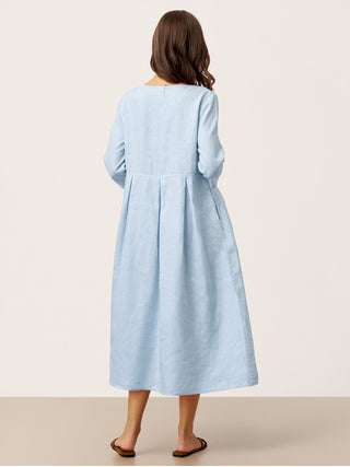 Baby blue linen maxi dress with crescent neck and decorative buttons, featuring waist pleats, by LINTICO.