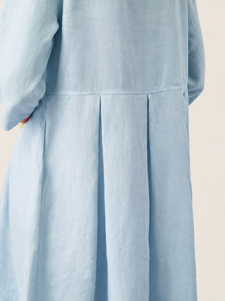 Baby blue linen maxi dress with crescent neck, decorative buttons, and pleated waist from LINTICO's GWENYTH collection.
