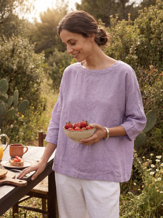 Lavender linen boatneck blouse with 3/4 length sleeves by LINTICO, featuring a relaxed fit and natural fabric texture.