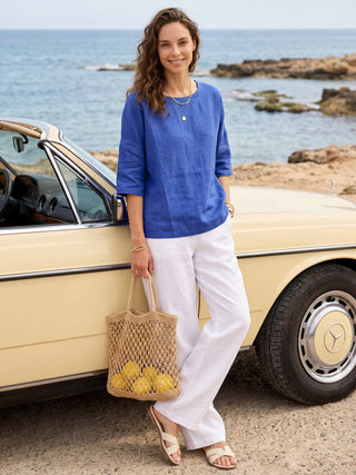 Royal blue linen boatneck top with 3/4 length sleeves from LINTICO, styled as a casual blouse or summer top.