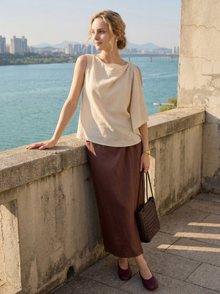 LINTICO Livana 100% linen twist-waist slit skirt in espresso brown, styled as part of a linen skirt set.