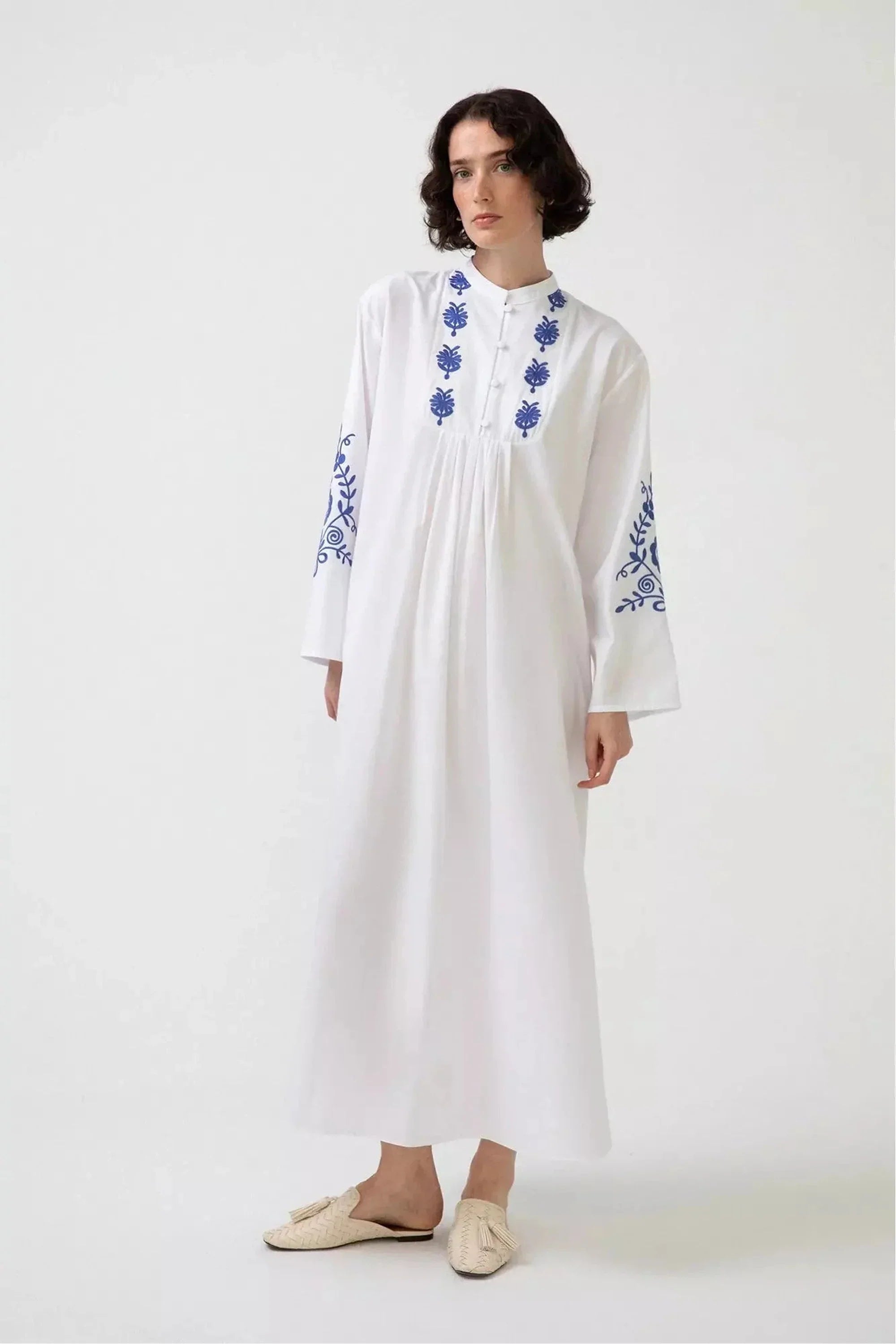 White embroidered dress with long sleeves by Baano, featuring intricate embroidery and elegant design.