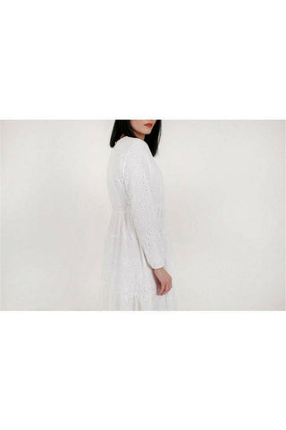 White cotton Sienna midi dress by BY Baano, featuring a flowing silhouette and elegant design, shown on a model.