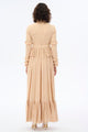 Beige high collar lace dress by By Baano, showcasing intricate lace details and a sophisticated high neckline.