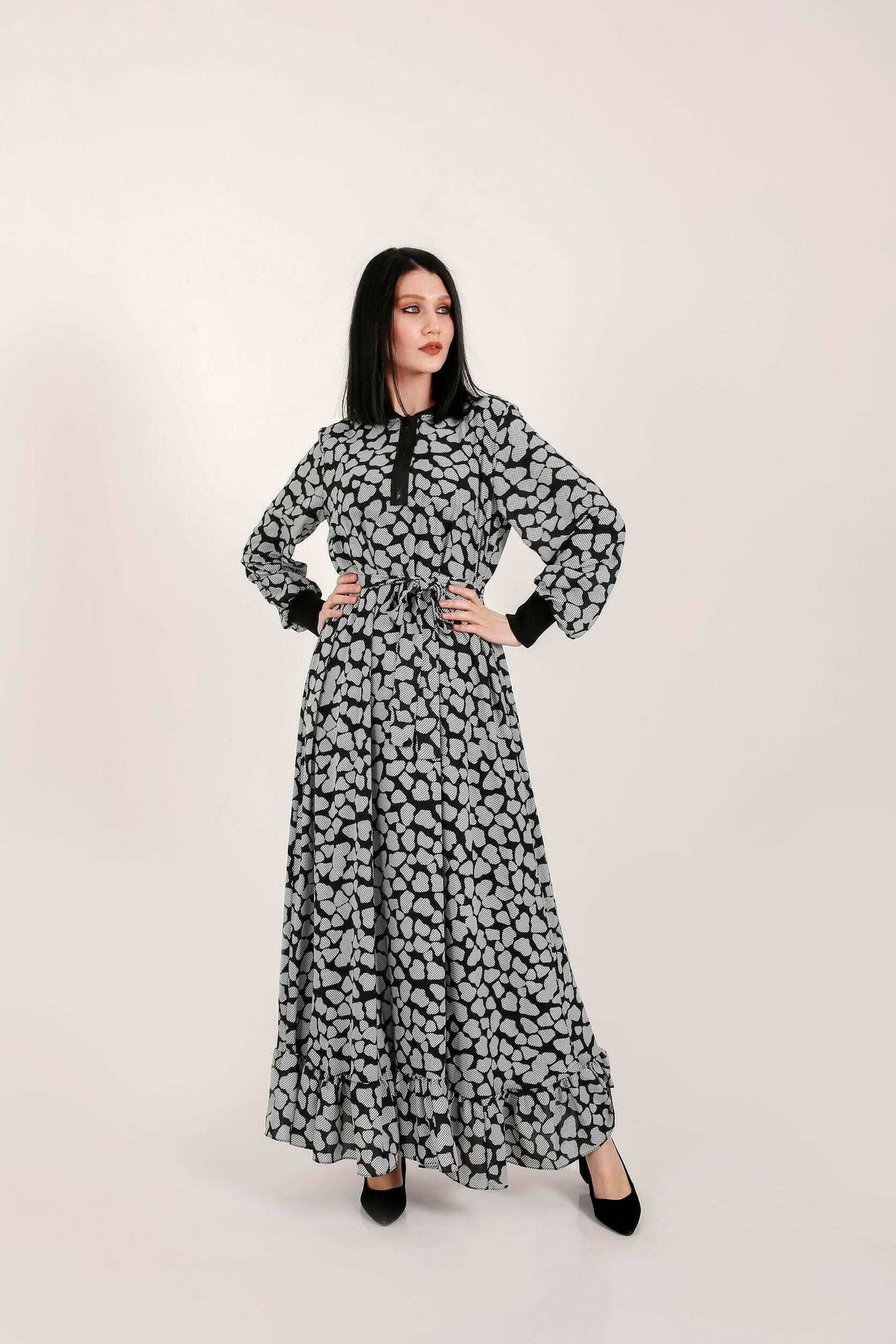 BY Baano Lola Long Maxi Dress featuring elastic cuffs and neckline, flowing fabric, and elegant style.