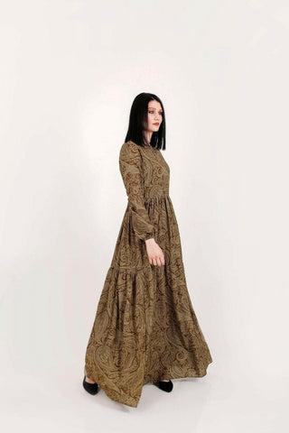 BY Baano Yalda Modest Maxi Dress in olive green with long sleeves, flowing fabric and elegant design for chic modest style.
