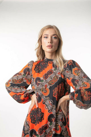 Printed Zara maxi dress by Baano featuring long sleeves, flowing fabric, and vibrant floral pattern.