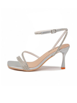 Pair of J.Adams Chloe metallic silver heels with pointed toes and stiletto heels, stylishly displayed on a neutral background.