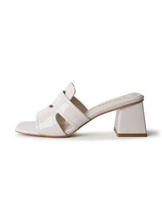 Beige patent Deborah sandals by J.Adams with ankle straps and open toe design, displayed on a neutral background.