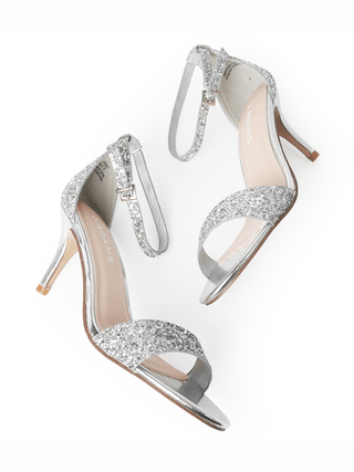 J. Adams silver glitter heels with open toe design and ankle strap, featuring a stylish and sparkly heel for elegant occasions.
