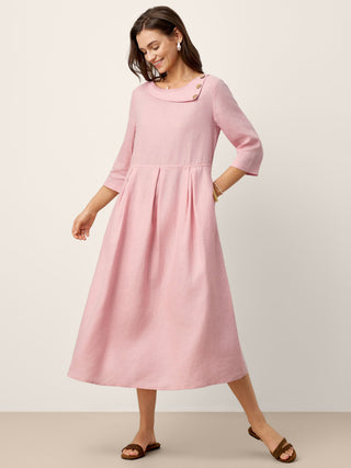 LINTICO linen maxi dress with crescent neck, decorative buttons, and waist pleats, featuring a flowing silhouette and elegant design.