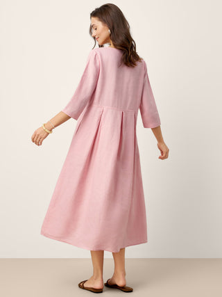 LINTICO linen maxi dress with crescent neckline, decorative buttons, waist pleats, in a flowing design.