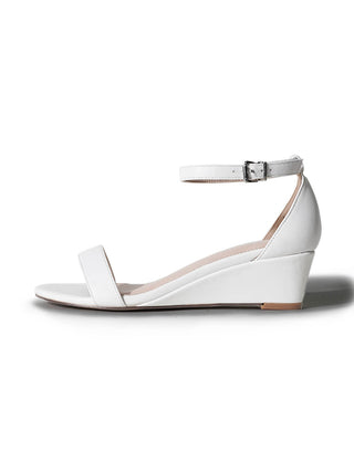 White wedge sandals by J.Adams featuring a stylish design, perfect for casual or dressy summer outfits.